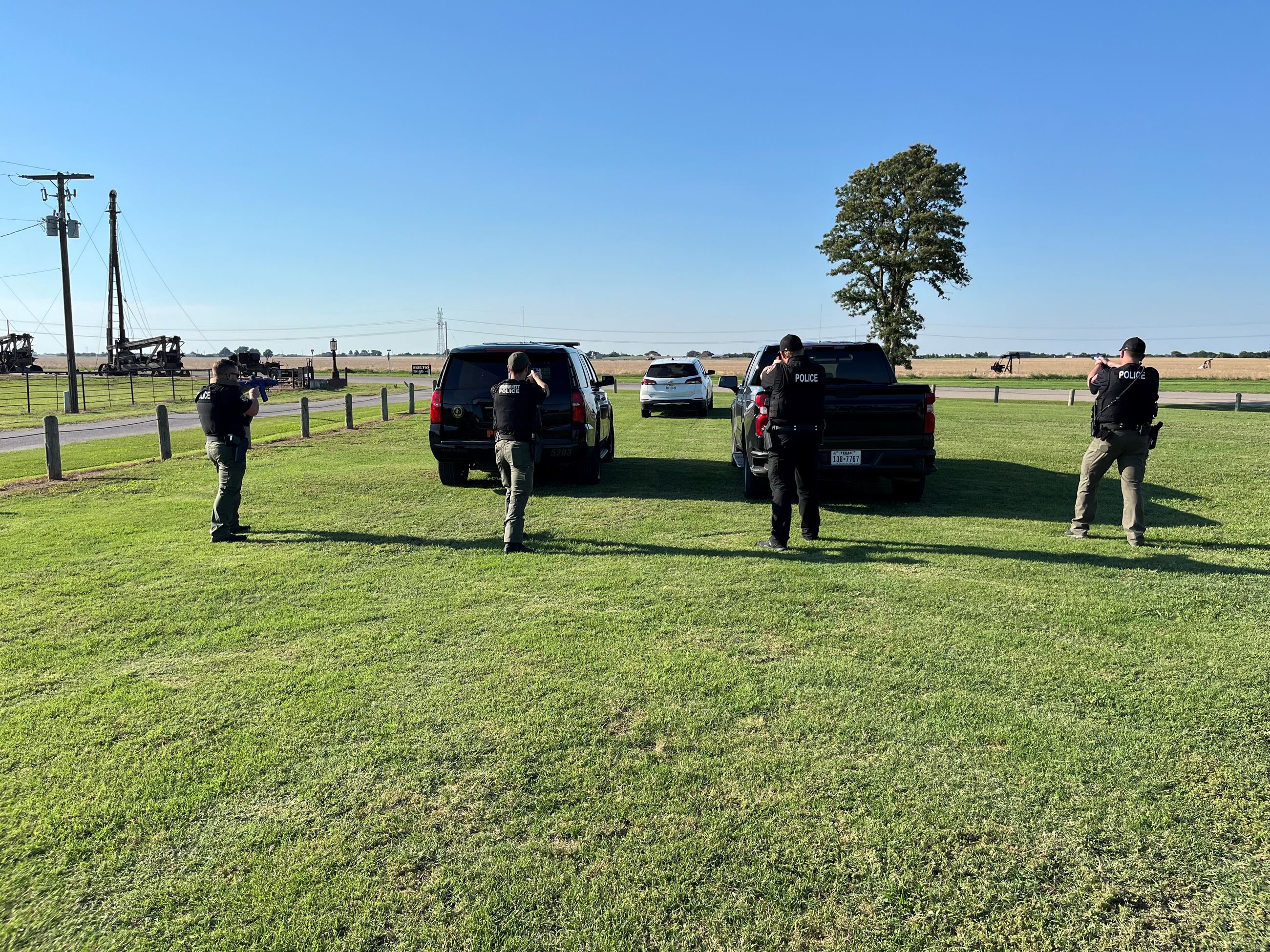 Officers standing behind black Police Tahoe ordering Driver of white suv to get out of the vehicle