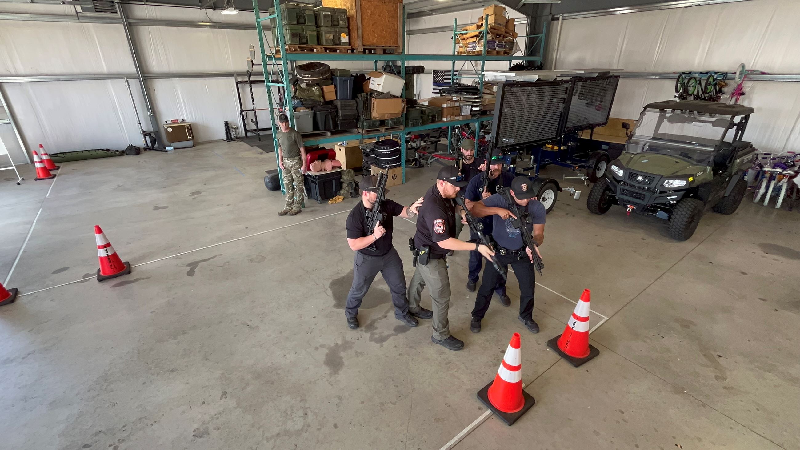 five police officer suing traffic cones for training on room entry